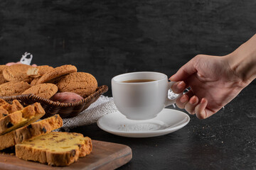 Close up photo of Female hand taking cup of tea