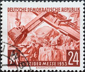 GERMANY, DDR - CIRCA 1953 : a postage stamp from Germany, GDR showing the fairgrounds, excavators....