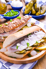 Dutch herring. Toast with Dutch herring, onions, pickles. Traditional rustic appetizer with seafood. Popular food in the netherlands. Vertical video, for social networks. 