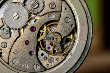 Fototapeta na wymiar vintage old mechanism with gears and springs, clock mechanism close-up. 