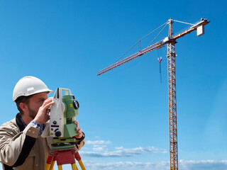 Land surveyor works on geodetic total station