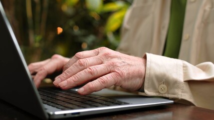 An old man is using laptop