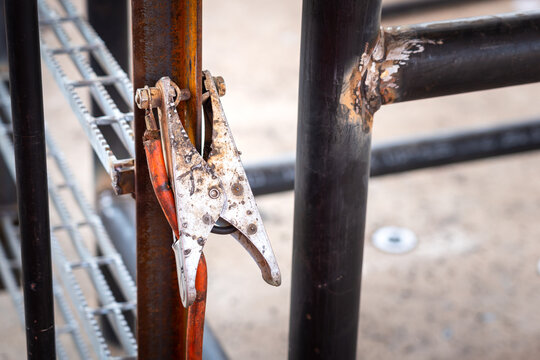A welding grounding clamp that clamping on metal structure, using as electrical shock preventive safety device. Industrial object photo.
