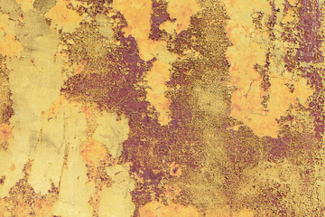Old rusty metal surface with yellow and brown paint flaking and cracking texture.	