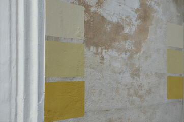 before painting the facade of the historic house, experimental painting of pigment paint samples is...