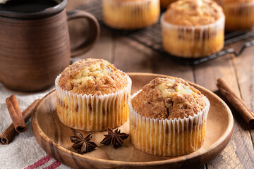 Two Cinnamon Muffins on a Wooden Plate