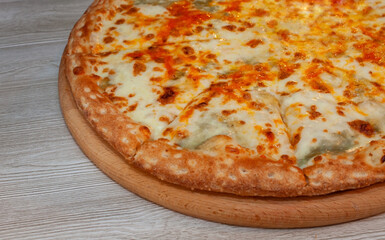 Four cheese pizza on a board
