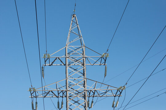 High-voltage poles. Transmission line support grid posts