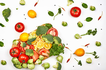 Fresh vegetable background on white background - tomatoes, lemon, broccoli and green herbs