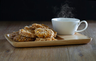 Thai sweet crispy fried rice and pour sugar, Thai call *Kao Tan* thai dessert and hot coffee in the wooden brown tray
