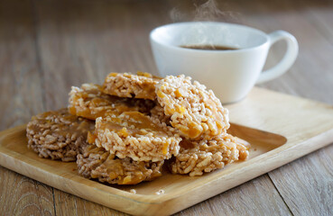 Thai sweet crispy fried rice and pour sugar, Thai call *Kao Tan* thai dessert and hot coffee in the wooden brown tray