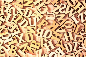 English alphabet. Wooden letters on a wooden background.