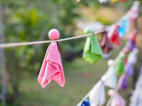 Japanese rain doll or Teru teru bouzu hanging in row