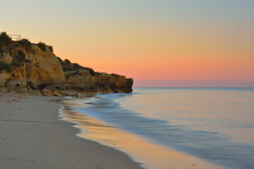 rocks in the ocean waters in albufeira on a sunny summer day - algarve, portugal