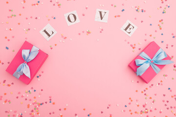 Composition with love inscription and gifts on pink background. Flat lay