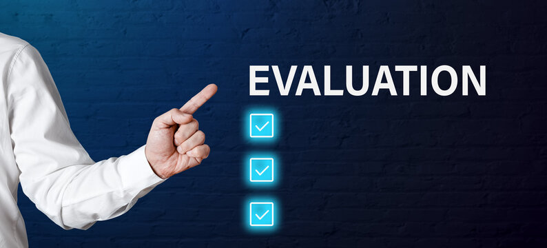 Businessman hand points to the word evaluation with tick check mark icons. Assessment criteria in business