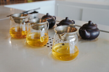 Set of tea cups and a teapot on a white table 