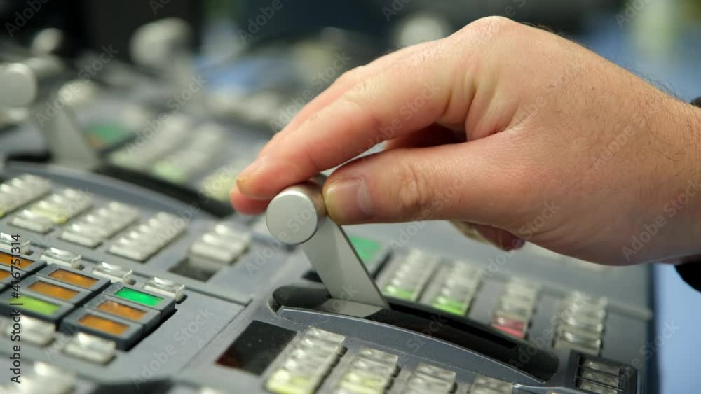 Wall mural hand adjusting on switcher buttons in studio tv station, television broadcast.