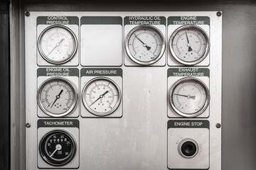 Group of of analog pressure and temperature measuring gauge on the control panel of machinery...