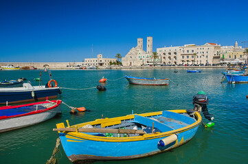 Fototapeta na wymiar View of the old harbour of Molfetta with little colourful boats, Puglia, Italy