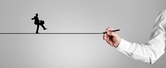 Businessman draws a bridge line with a silhouette man icon to walk across.