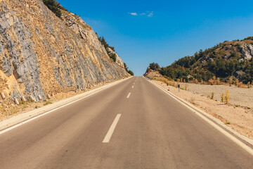 Road in the hills and mountain. Sunny day, no cars, no people