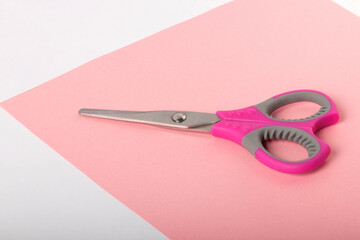 Pink scissors for cutting sheets of paper and fabric. For office and home work. Stationery.