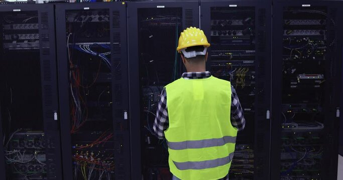 Technician man at work inside server room