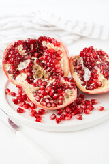 Fresh ripe pomegranate in a plate, pomegranate seeds