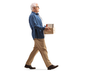 Mature man walking with a crate with books