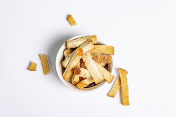 Homemade croutons in bowl isolated on white background