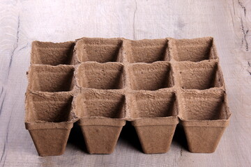 Empty peat pots on gray wooden background. Peat pots for seedling