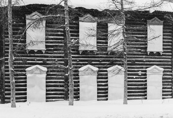 Old wooden houses under the snow. Russia. Siberia. Winter. Boarded up windows. The city of Tomsk 2021