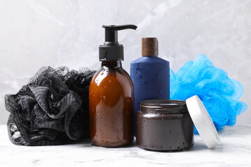 Cosmetic products and bast wisps on white marble table. Men's hygiene