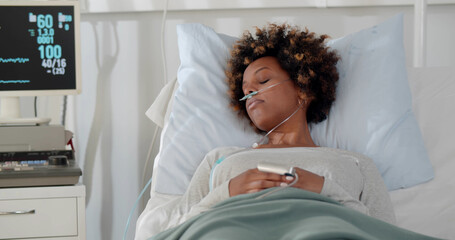 African sad woman lying with fever on bed in hospital indoor