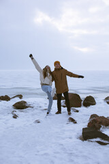 A romantic photo session of a girl and a guy in the Gulf of Finland in winter. Love story and happiness.