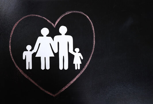 Paper family and heart drawn on a school blackboard. Love concept