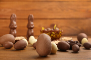 Sweet chocolate eggs on wooden table. Space for text