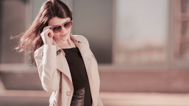 Portrait of a modern business woman on a city background.