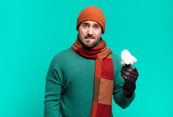 adult handsome man looking puzzled and confused, biting lip with a nervous gesture, not knowing the...