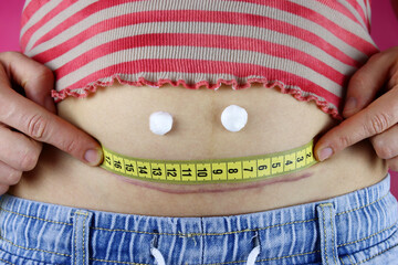 Smile from the cream on the stomach with a caesarean section. The concept of postpartum recovery