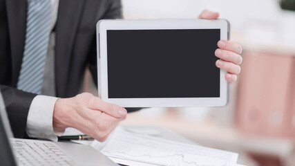 Fototapeta na wymiar close up.businessman showing tablet with blank screen