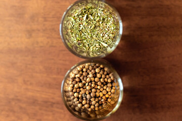 Spices for cooking in glass tubes. Brown background.