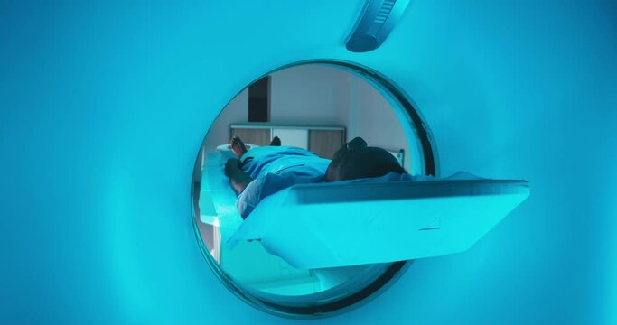 Black patient entering modern CT machine
