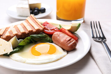 Delicious breakfast with fried egg served on white table, closeup
