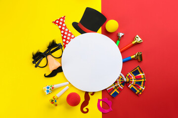 Flat lay composition with clown's accessories and card on color background, space for text
