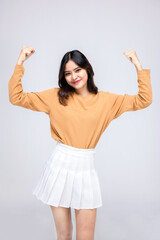 Portraits of young Asian women. Raise both arms. With a smiling face happily, a beautiful woman with a sense of self-confidence, looks good, happy on a white background.