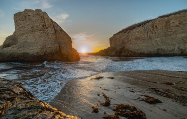 A picturesque sunset in Shark Fin cove, ocean, rocks, beautiful sky. Santa Cruz and Davenport have some of the most beautiful beaches in California.