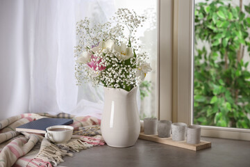 Beautiful fresh flowers on window sill indoors