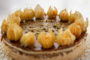 summer cake sweet baked dessert physalis chocolate caramel cheesecake with pistacios sprinkle on top 